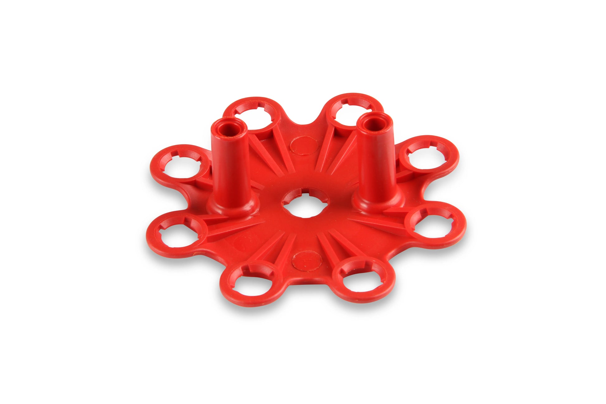 Red plastic component on a white background